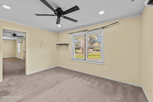 empty room with ceiling fan, light colored carpet, and ornamental molding