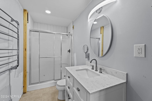 bathroom featuring vanity, radiator heating unit, an enclosed shower, tile patterned floors, and toilet