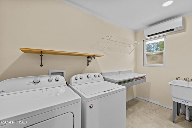 laundry room featuring an AC wall unit and washer and dryer