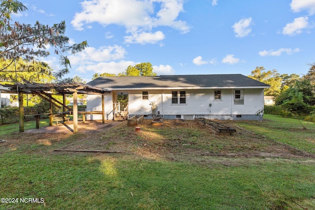 rear view of house with a patio, a pergola, and a lawn