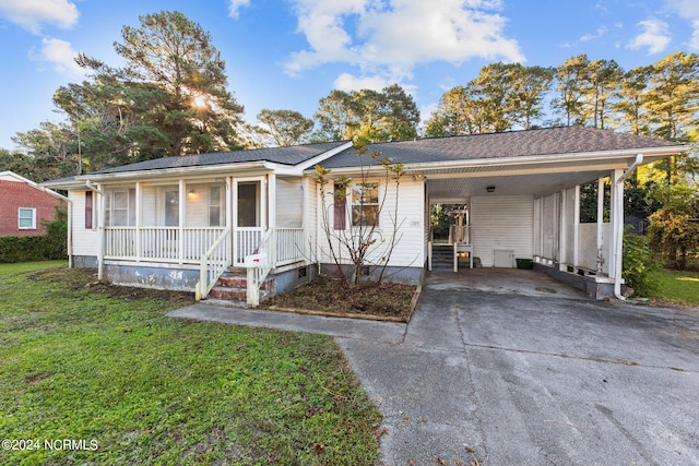 ranch-style house featuring a carport and a front yard