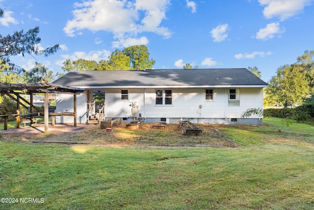 rear view of property with a pergola, a lawn, and a patio area