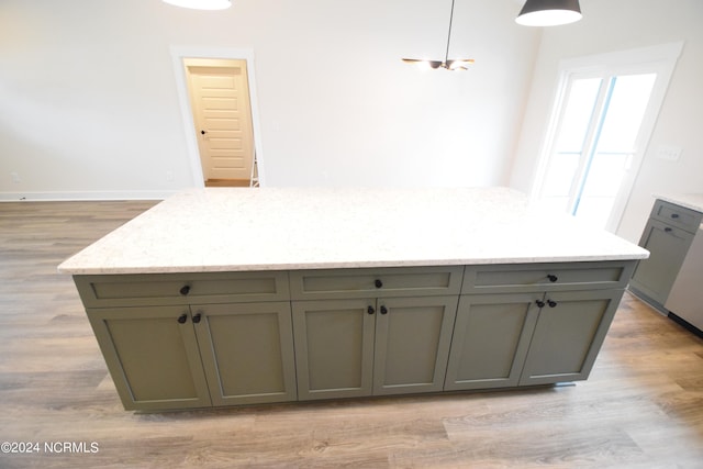 kitchen featuring light stone counters and light wood-type flooring