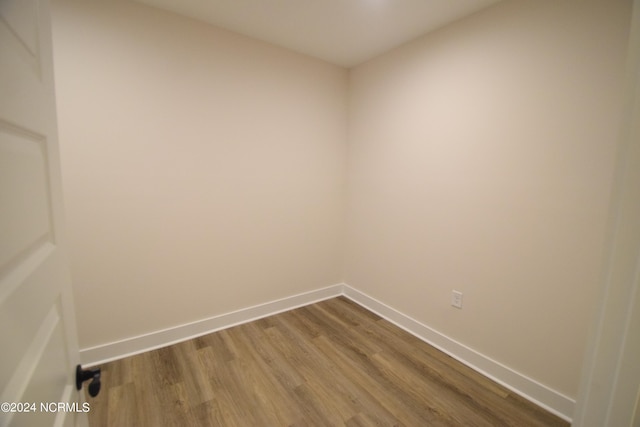 unfurnished room with wood-type flooring