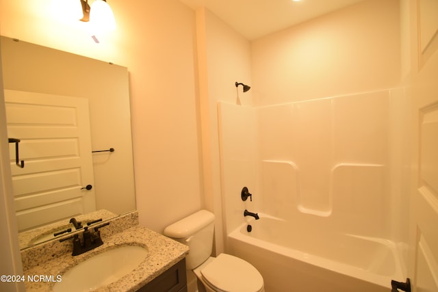 full bathroom featuring vanity, bathing tub / shower combination, and toilet