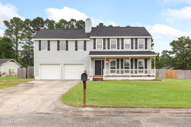 view of front of home featuring a front yard, covered porch, and a garage