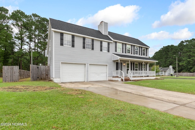 view of front of property featuring a porch, a front yard, and a garage