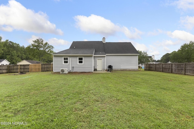 rear view of house with a chimney, roof with shingles, ac unit, a fenced backyard, and a yard