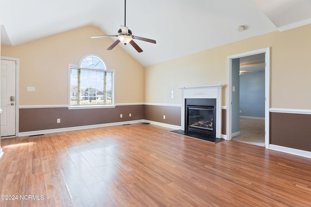 unfurnished living room featuring vaulted ceiling, light hardwood / wood-style flooring, and ceiling fan