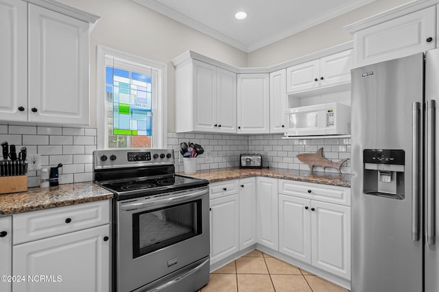 kitchen with ornamental molding, white cabinets, tasteful backsplash, and stainless steel appliances