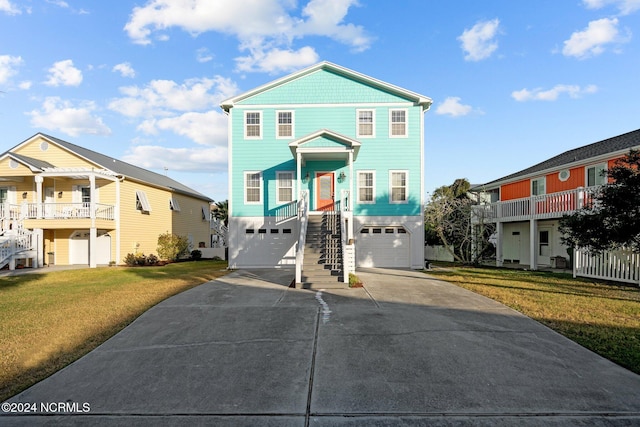 view of front of home featuring a balcony, a front lawn, and a garage