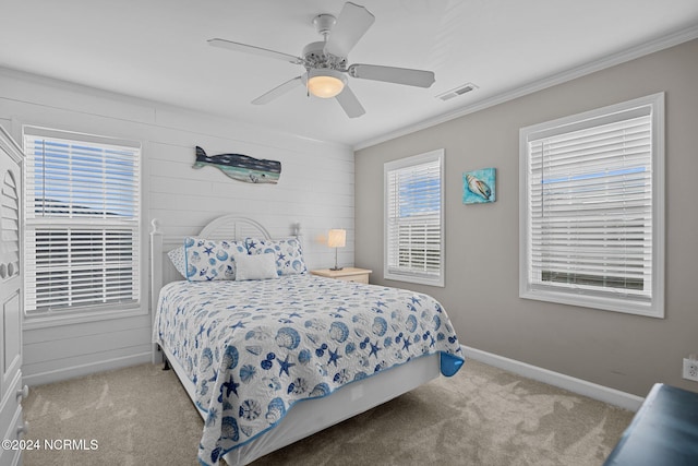 bedroom with ornamental molding, light carpet, and ceiling fan