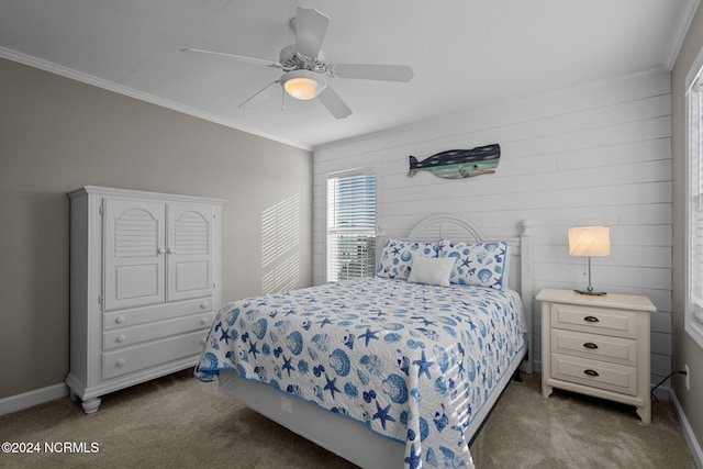 bedroom with ceiling fan, ornamental molding, and dark colored carpet