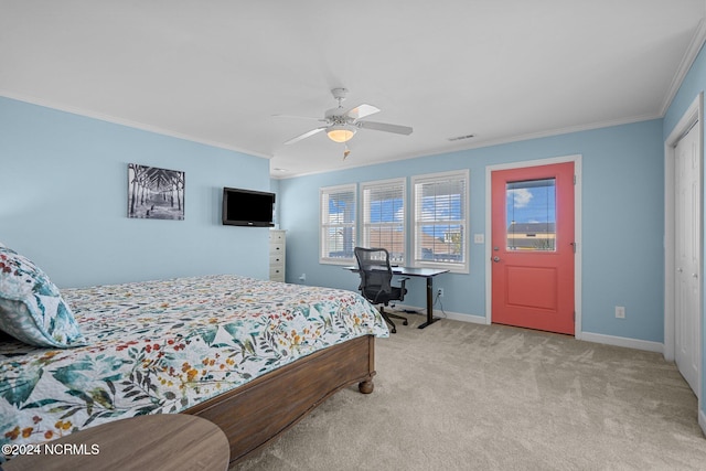 carpeted bedroom with a closet, ornamental molding, and ceiling fan