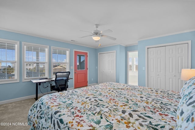 bedroom featuring light carpet, multiple windows, multiple closets, and ceiling fan