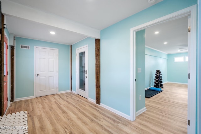 hallway with light hardwood / wood-style floors