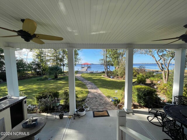 view of patio / terrace with a water view and ceiling fan