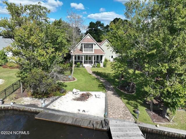 rear view of property with a lawn