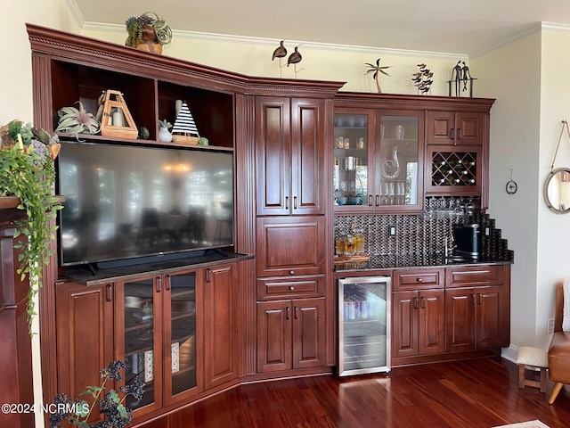 bar featuring crown molding, beverage cooler, and dark hardwood / wood-style flooring