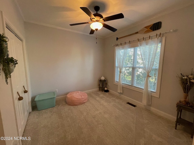 misc room with light carpet, ornamental molding, and ceiling fan