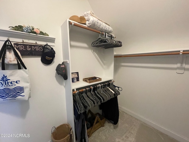 walk in closet with carpet floors