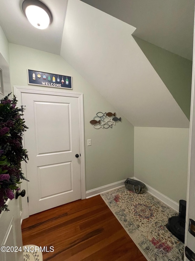 interior space with vaulted ceiling and dark hardwood / wood-style floors