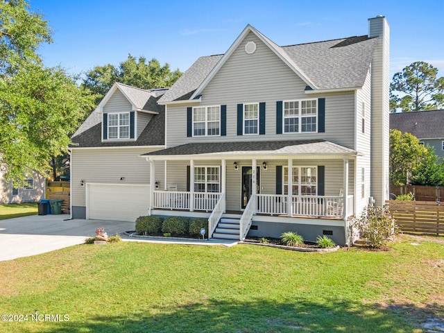 view of front of property with a garage, a front yard, and covered porch