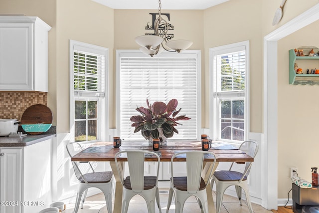 dining area with an inviting chandelier