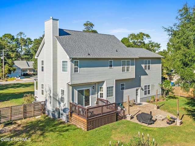 back of property featuring a patio, a lawn, and a deck