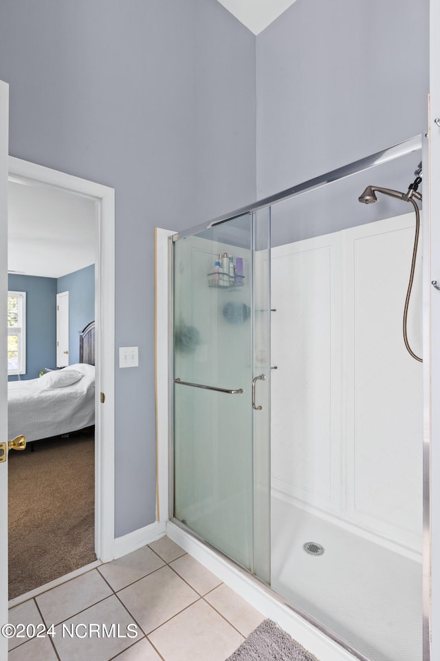 bathroom with walk in shower and tile patterned floors