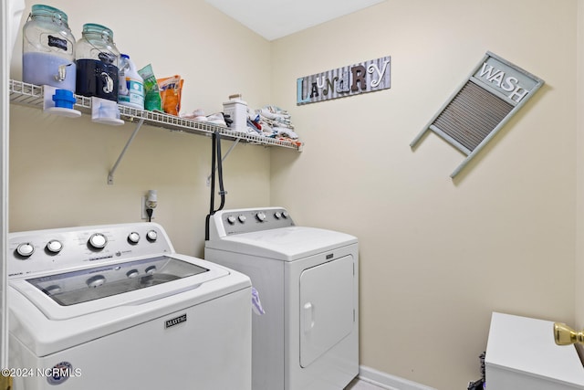 clothes washing area with washing machine and dryer