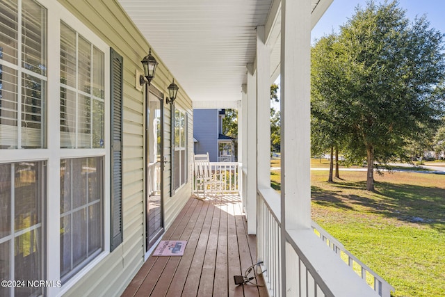 wooden terrace featuring covered porch