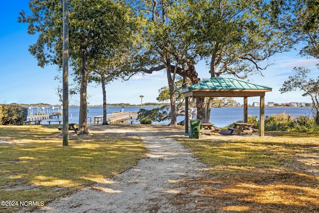 view of home's community with a gazebo, a yard, and a water view