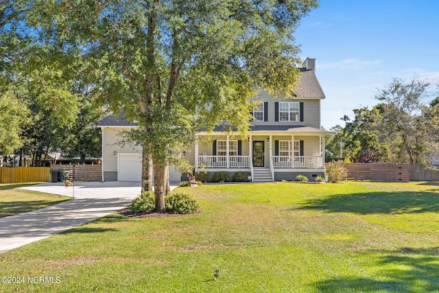 view of front of house featuring a garage, a porch, and a front yard