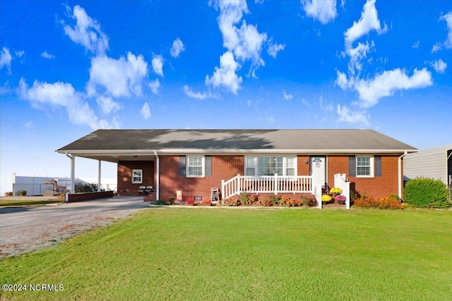 ranch-style home with a front lawn and a carport