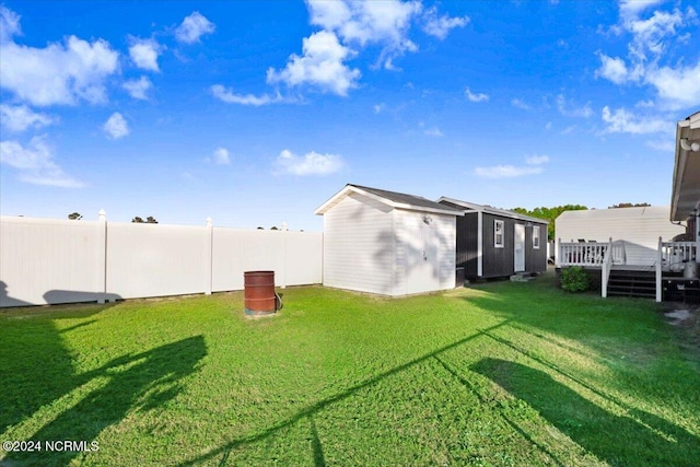 view of yard with a wooden deck and a shed