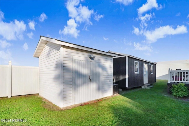 view of outdoor structure featuring a lawn