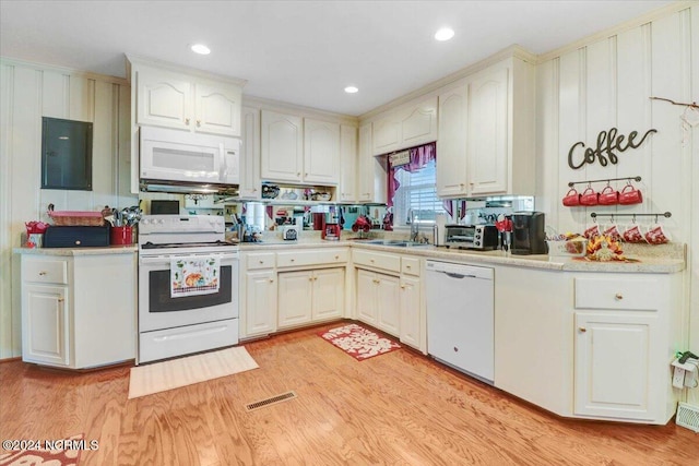 kitchen featuring white appliances, electric panel, sink, and light wood-type flooring