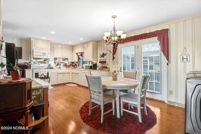 dining space with a chandelier and light hardwood / wood-style flooring