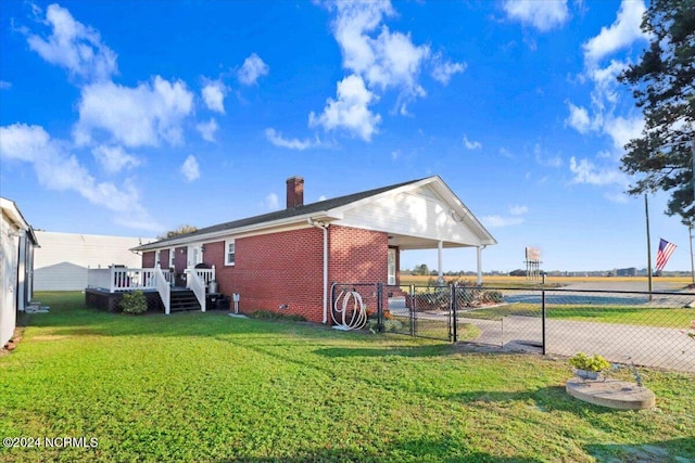 view of home's exterior featuring a deck and a yard