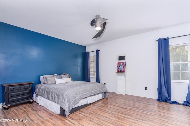 bedroom featuring wood-type flooring and ceiling fan