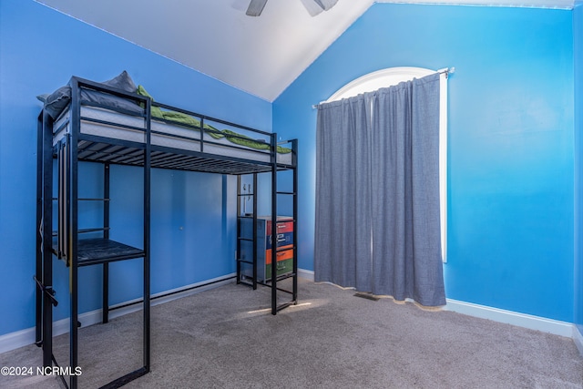 unfurnished bedroom featuring lofted ceiling, carpet floors, and ceiling fan