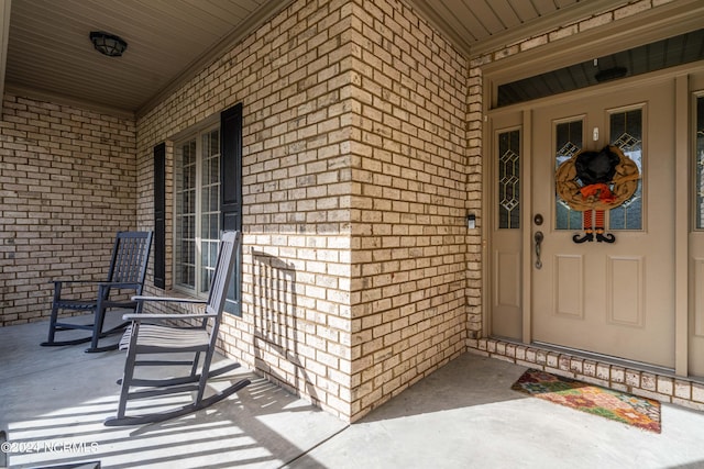 view of exterior entry with a porch