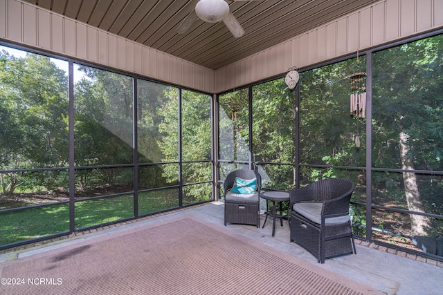 unfurnished sunroom with wood ceiling and ceiling fan