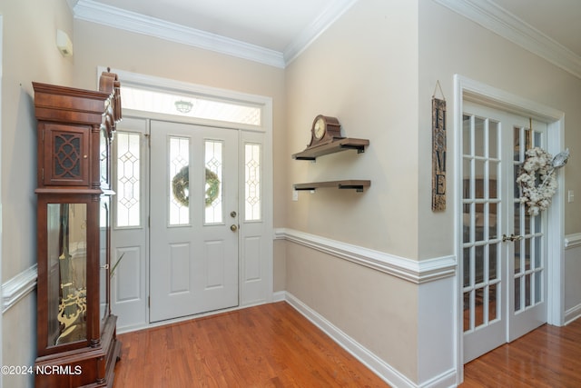 foyer featuring ornamental molding and hardwood / wood-style flooring