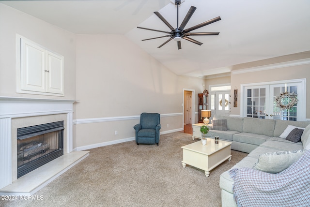 living room featuring french doors, ceiling fan, light carpet, lofted ceiling, and a premium fireplace