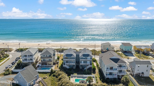 drone / aerial view featuring a beach view and a water view