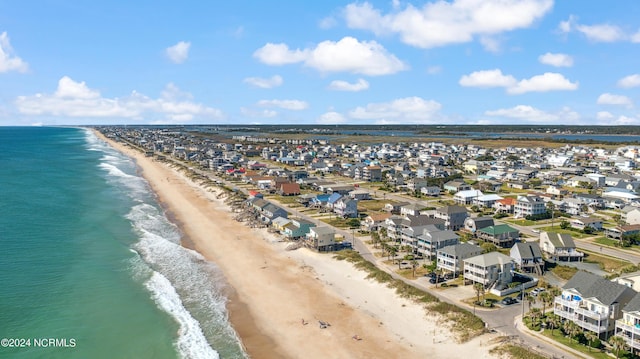 birds eye view of property featuring a beach view and a water view