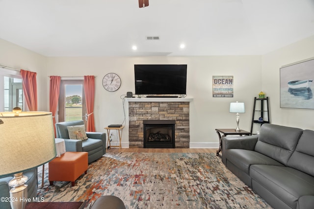 living room featuring wood-type flooring and a fireplace