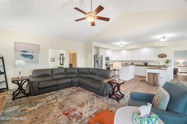 living room with sink, high vaulted ceiling, light hardwood / wood-style floors, and ceiling fan